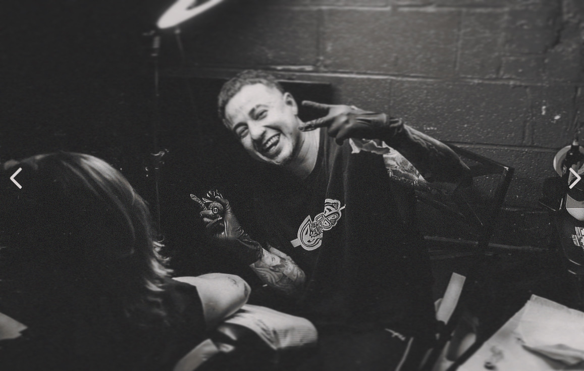 Young Inkaholics tattoo artist working with a client in the studio