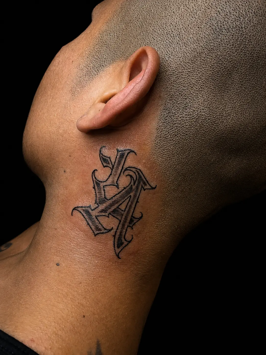 Gothic lettering neck tattoo