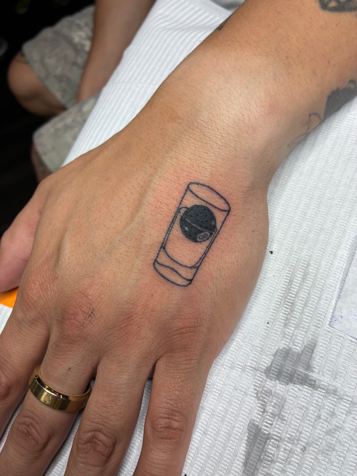 Minimal 8-ball drink hand tattoo